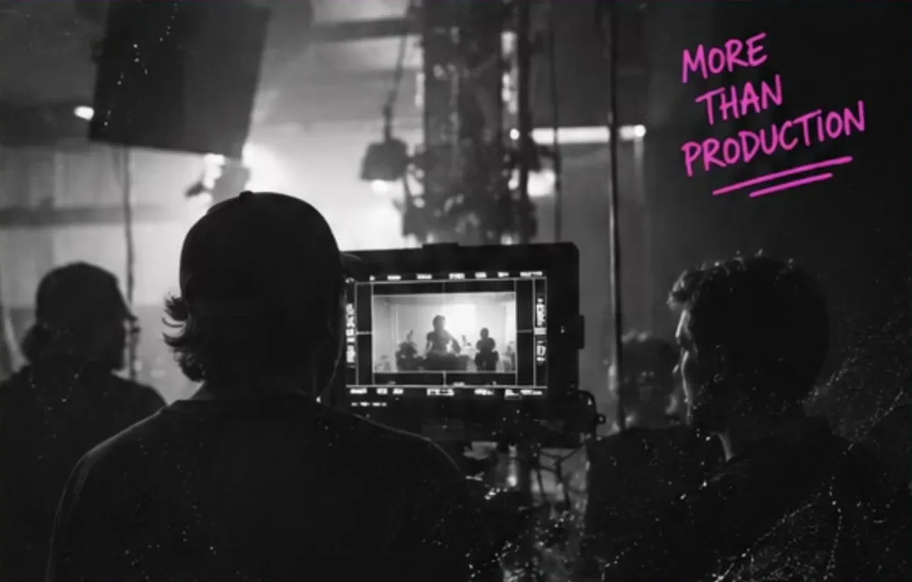 Production crew watching a monitor on set